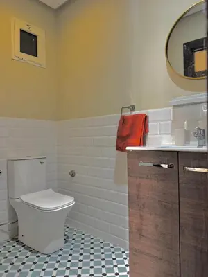 a bathroom with a toilet and a sink and a mirror at Appartement à 2 min Gare agdal in Rabat