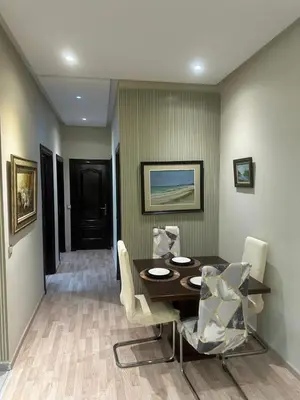 a dining room with a table and chairs at Appartement à 2 min Gare agdal in Rabat