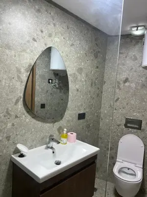 a bathroom with a sink and a toilet and a mirror at L'osmo - 1 BR - 2m from CFC in Casablanca