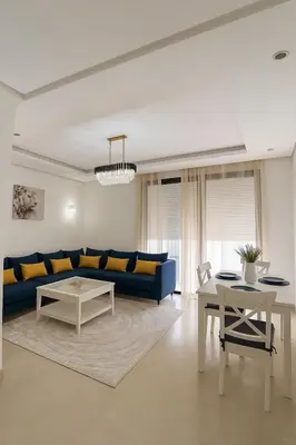 a living room with a blue couch and a table at Luxury Stay Rabat Serenity in Rabat