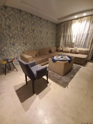 a living room with a couch and a chair at La perle home 21 in Casablanca-Port