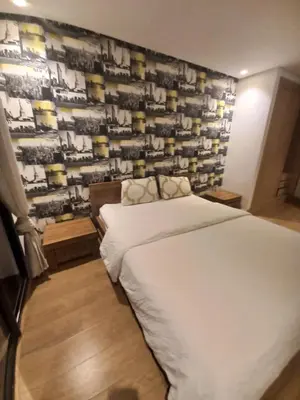 a bedroom with a bed and a wall with a picture at La perle home 21 in Casablanca-Port