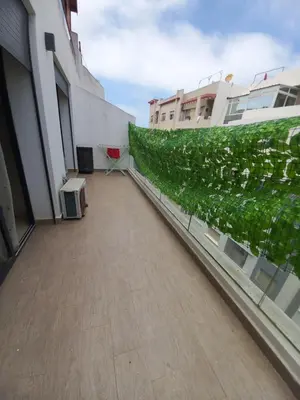 a balcony with a green wall on the side of a building at La perle home 21 in Casablanca-Port