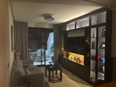 a living room with a couch and a large entertainment center at La terrasse in Casablanca