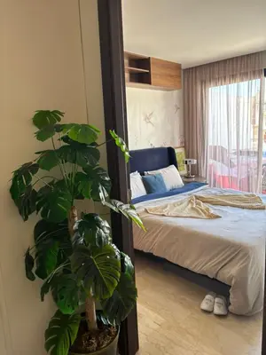 a bedroom with a bed and a potted plant at La terrasse in Casablanca