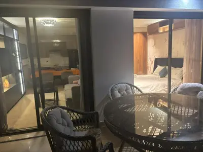a room with a table and chairs and a bedroom at La terrasse in Casablanca