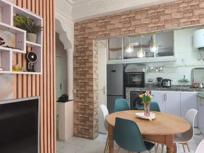 a kitchen and dining room with a table and chairs at Baraka house in Sidi Yahia az Zaʼer