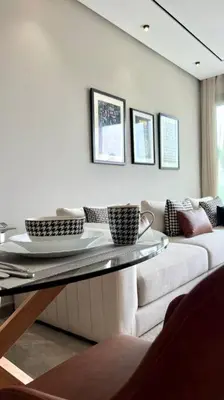 a living room with a couch and a glass table at Anfa The Address - By AppartAli in Casablanca