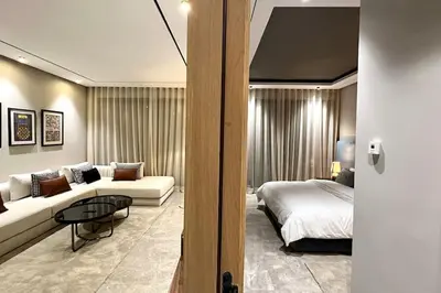 a bedroom with a bed and a couch and a table at Anfa The Address - By AppartAli in Casablanca