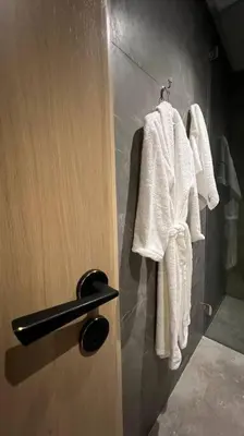 a bathroom with white towels hanging on a door at Casa The Address - By AppartAli in Casablanca