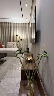 a living room with a couch and a vase with flowers at Casa The Address - By AppartAli in Casablanca