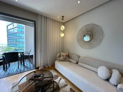 a living room with a couch and a glass table at Sea and Marina View - By AppartAli in Casablanca
