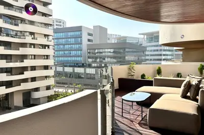 a balcony with couches and a table on a building at State of Peace in Marina - By AppartAli in Casablanca