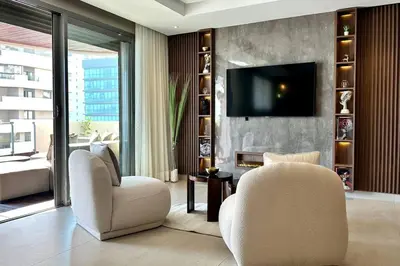 a living room with two chairs and a television at State of Peace in Marina - By AppartAli in Casablanca
