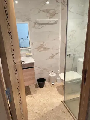 a bathroom with a shower and a toilet and a sink at Best appartement pools view at Mansouria in Pont Blondin