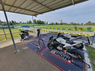 two motorcycles are parked on a race track at Best appartement pools view at Mansouria in Pont Blondin