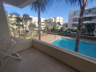 a balcony with a view of a swimming pool at Best appartement pools view at Mansouria in Pont Blondin