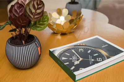 a clock and a potted plant on a table at La Terrazza at Marina - By AppartAli in Casablanca