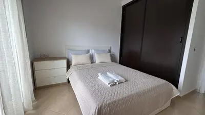 a bedroom with a bed with two towels on it at Apartement en Wifak Soleil, calme et sécurité in Temara