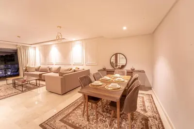 a living room with a table and chairs and a couch at Modern apartment with pool view Tamaris in Tamaris