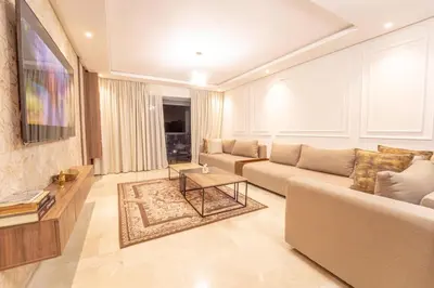 a living room with a couch and a table at Modern apartment with pool view Tamaris in Tamaris