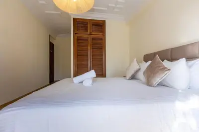 a bedroom with a large white bed with pillows at 3BR Apartment in Prestigious Hay Riad by MERAT HOME in Rabat