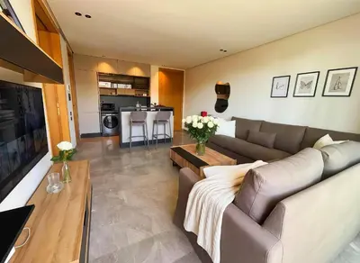 a living room with a couch and a table at Maya Suites - Opale Sea Side in Anfa-Supérieur
