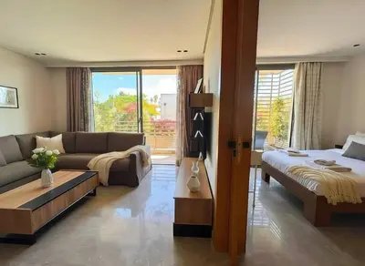 a living room with a couch and a bed at Maya Suites - Opale Sea Side in Anfa-Supérieur