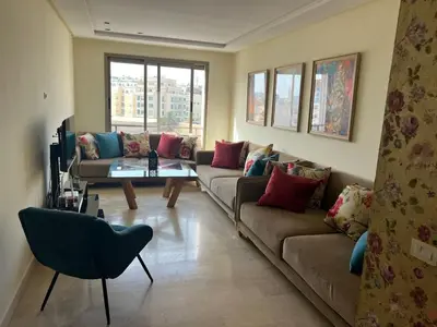 a living room with two couches and a table at Appartement vue sur le phare in Casablanca