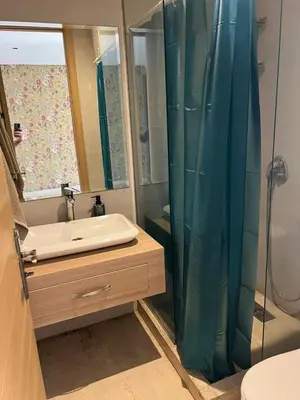 a bathroom with a sink and a shower at Appartement vue sur le phare in Casablanca
