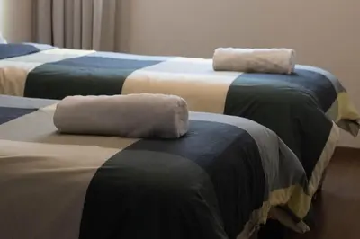 a group of three beds with towels on them at Appartement élégant a Parc Mohammedia - proche de la mer in Mohammedia