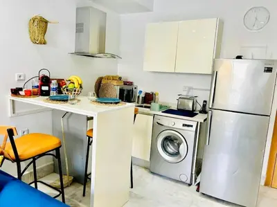 a kitchen with a refrigerator and a washing machine at Fundays Stay Casablanca in Casablanca