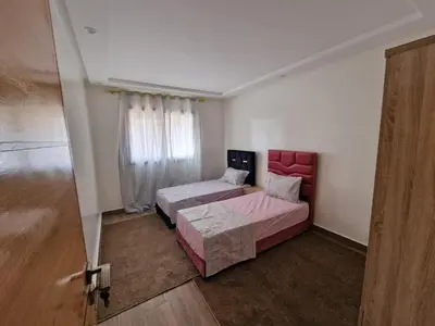 a room with two beds and a sliding door at فيكتوريا in Casablanca