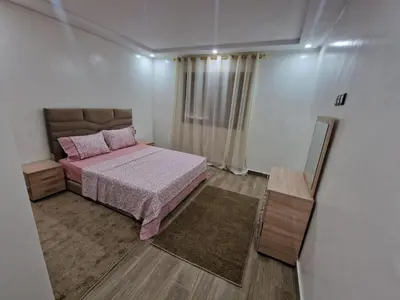 a small bedroom with a pink bed and a mirror at فيكتوريا in Casablanca