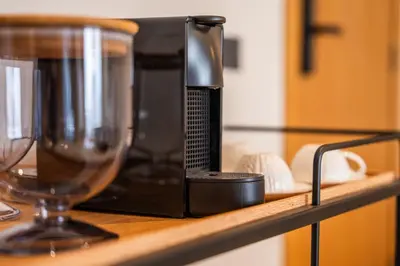 a microwave sitting on a shelf next to a wine glass at 3BR 3BA Family Apt Pool Gated Residence in Casablanca