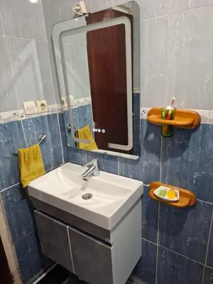 a bathroom with a sink and a mirror at Appartement Chahdia in Casablanca