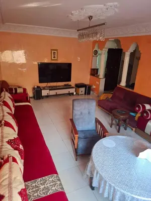 a living room with a couch and a tv at Appartement Chahdia in Casablanca