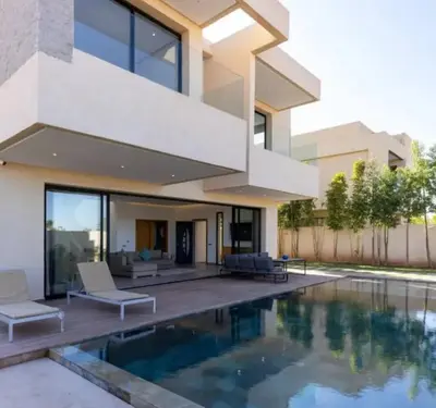 a house with a swimming pool in front of it at Villa Prestige in Bir Jedíd Saint-Hubert