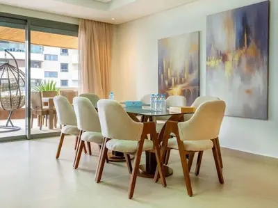 a dining room with a table and chairs at The Pearl - 3 Chambres Marina - By AppartAli in Casablanca