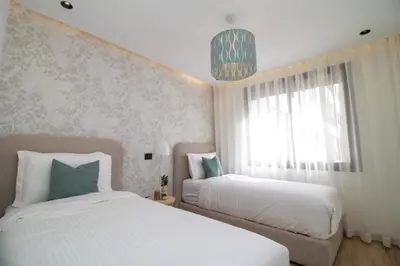 a bedroom with two beds and a window at 2 Bedroom Apartment City Center in Casablanca