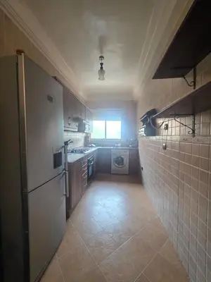 a kitchen with a refrigerator and a washing machine at Dar Tourabi in Casablanca