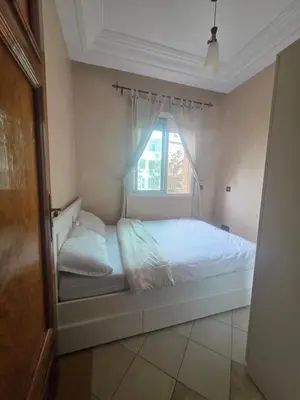 a white bed in a room with a window at Dar Tourabi in Casablanca