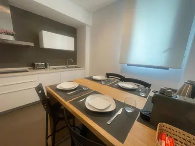 a kitchen with a table with plates and glasses on it at Nams Casa Home in Casablanca