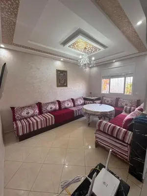 a living room with a couch and a table at Appatement authentique 7mn Hay Riad in Temara