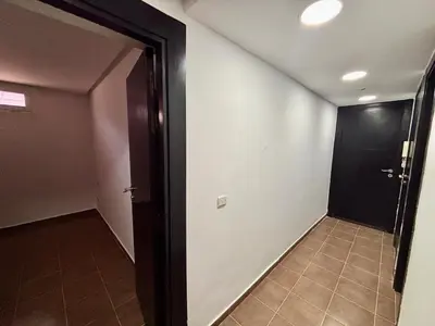 a hallway with a black door and a tile floor at Villa Miraluna ,Jacuzzi Retreat in Tamaris