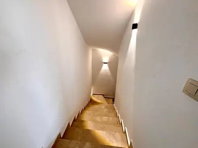 a stairway with a light at the end of a tunnel at Villa Miraluna ,Jacuzzi Retreat in Tamaris