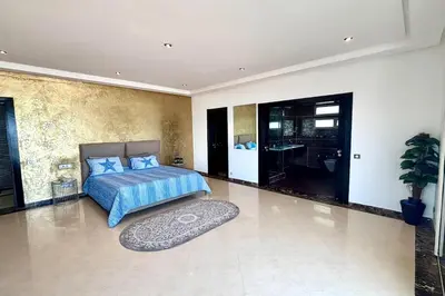 a bedroom with a bed and a rug at Villa Miraluna ,Jacuzzi Retreat in Tamaris