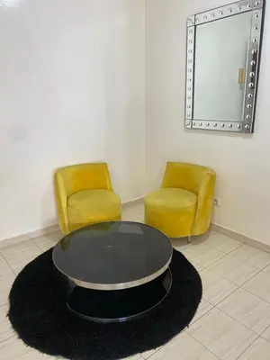 a room with two chairs and a table and a mirror at Saad home in Casablanca
