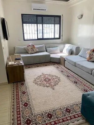a living room with a couch and a rug at Saad home in Casablanca