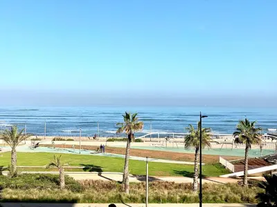 a view of a beach with palm trees and the ocean at Saad home in Casablanca